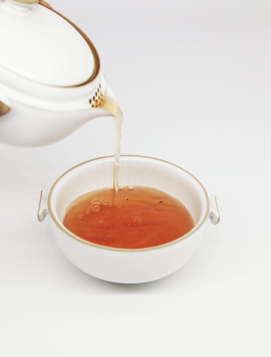 tea pours into white teacup